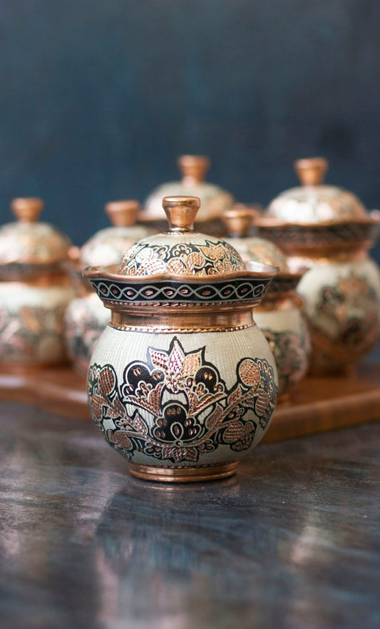 white and blue floral ceramic jar