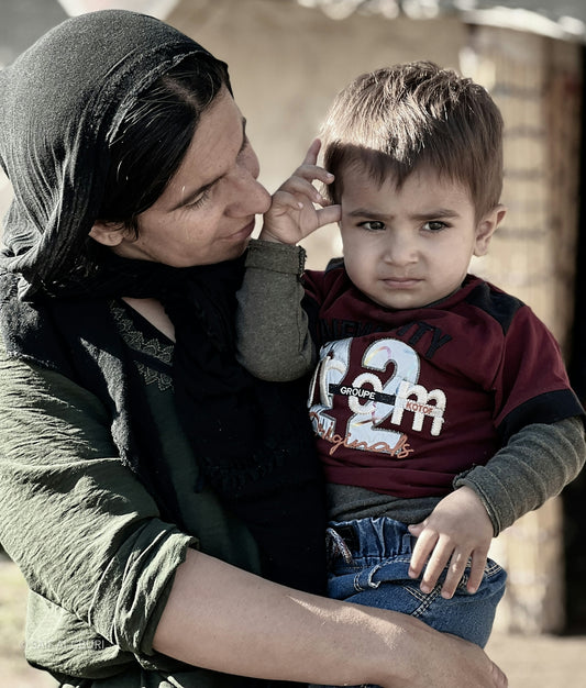 A woman holding a small boy in her arms